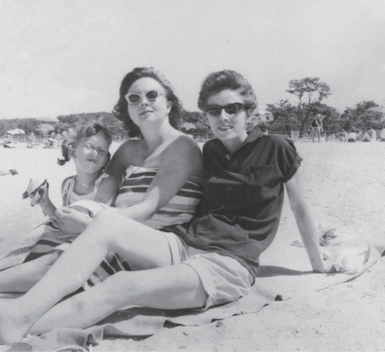A lesbian couple and their daughter at the beach.